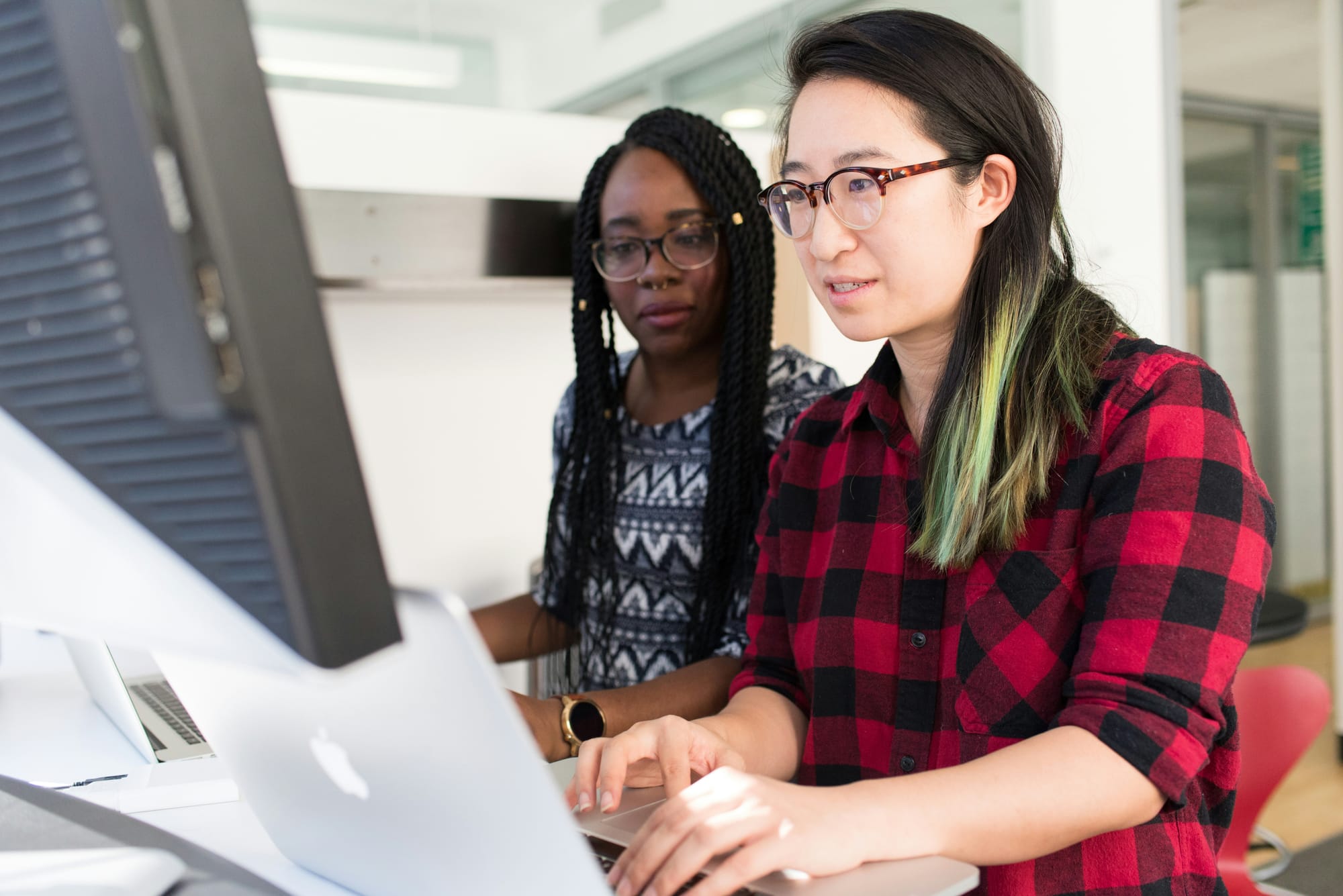 Two people collaborating at a computer