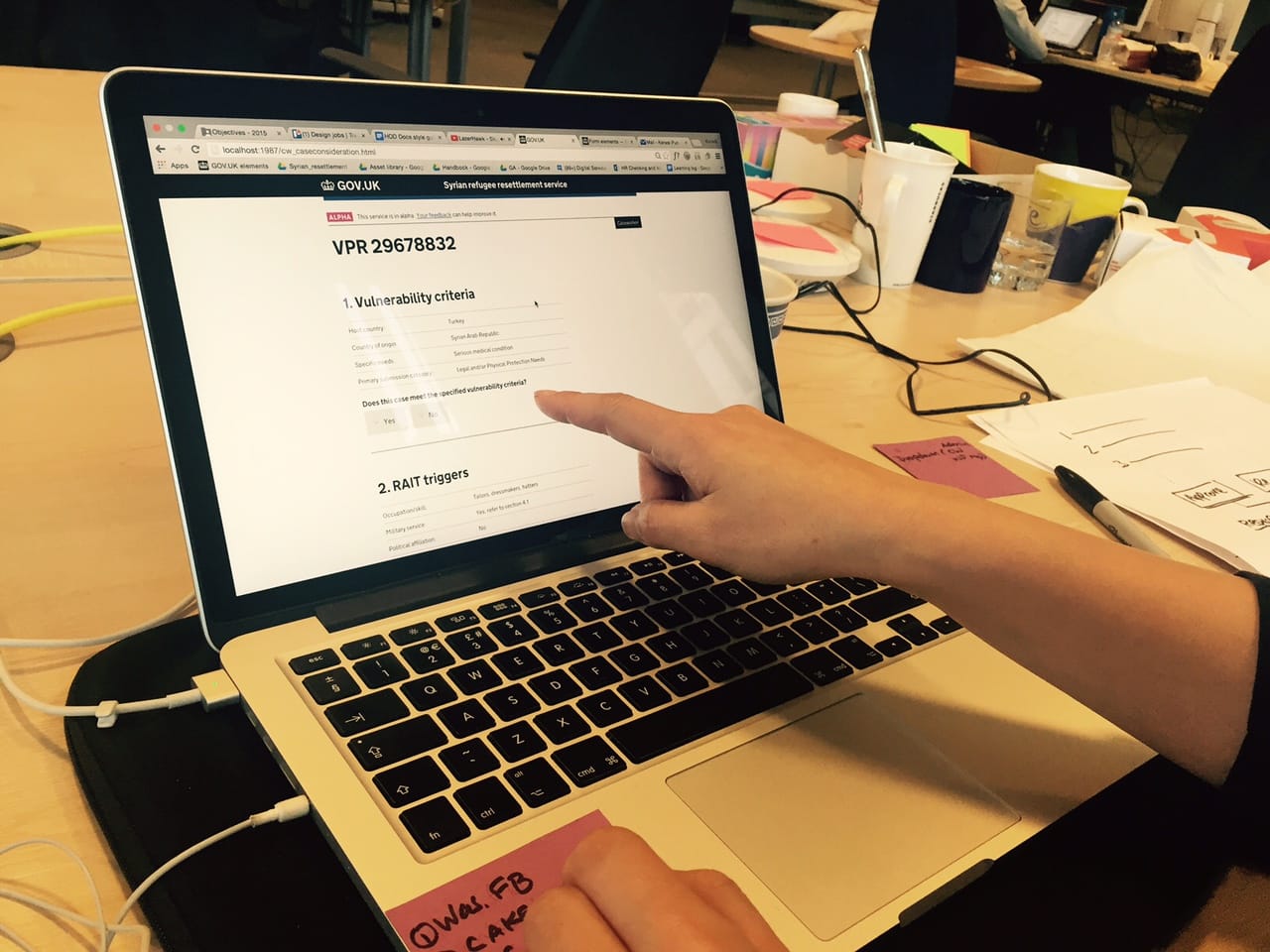 A GOV.UK alpha of the Syrian refugee resettlement service, open on a laptop during testing